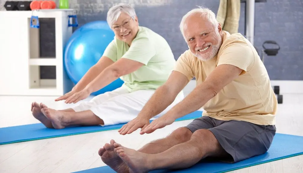 An elderly couple exercising
