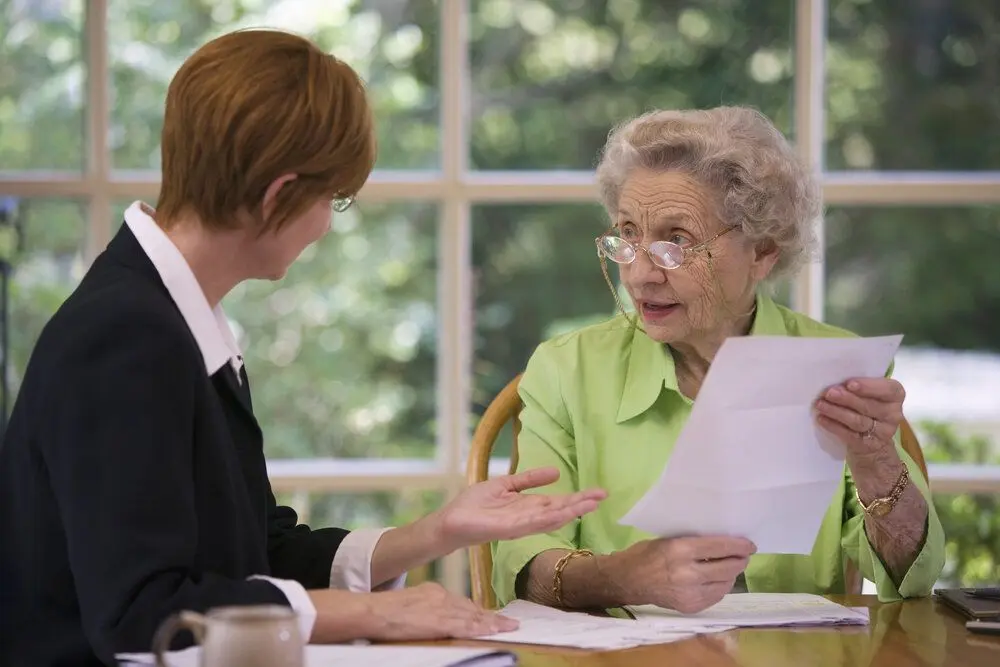An elderly lady with a lawyer