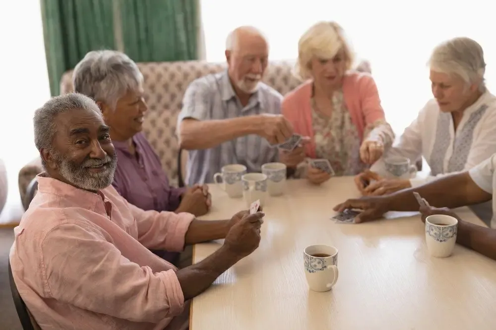 Care home residents playing cards