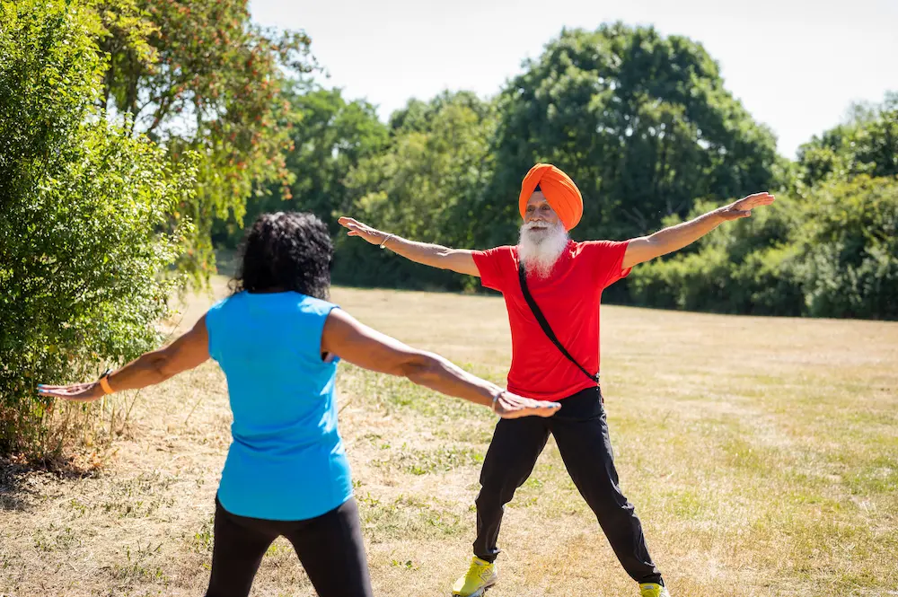 Elderly couple exercising in a field