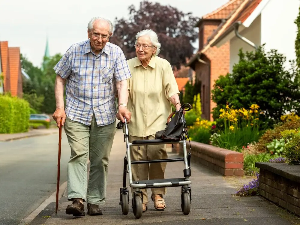 Elderly couple walking down the street