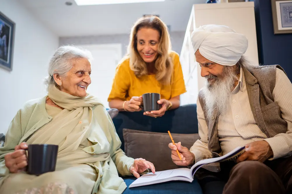 Female carer and an older Sikh couple
