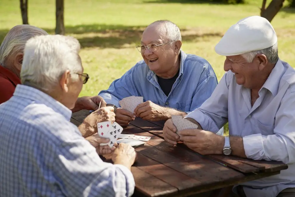Old people playing cards in a park