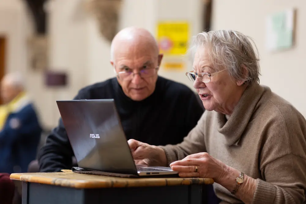 Older adults using a laptop together