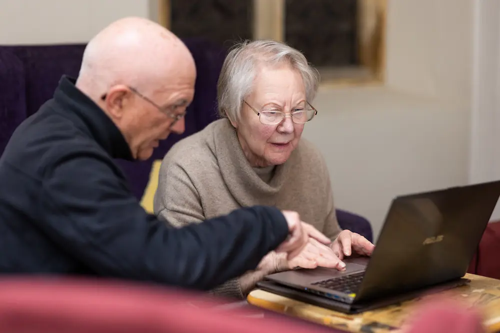 Older adults using a laptop together