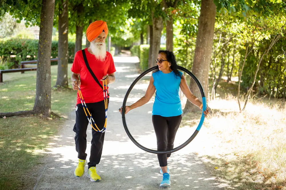 Older man and woman holding a skipping rope and hoop