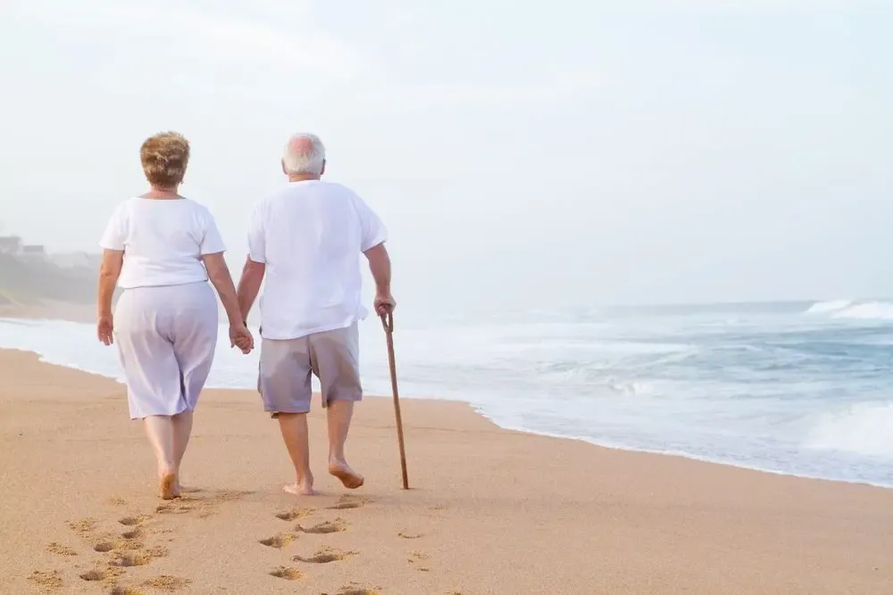 Older man and woman on a beach together