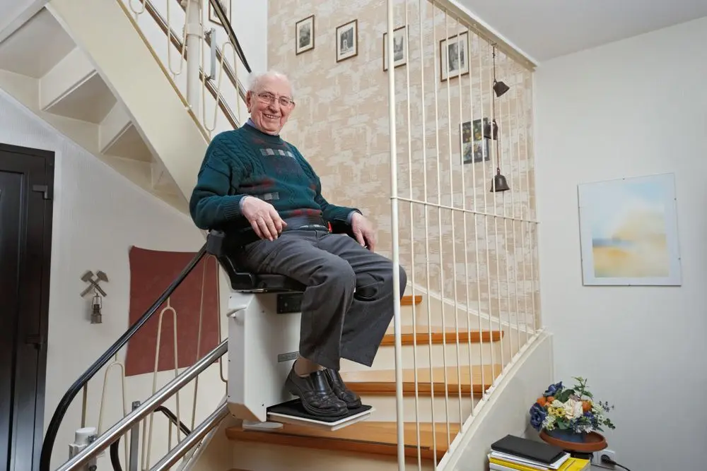 Older man using a stair lift