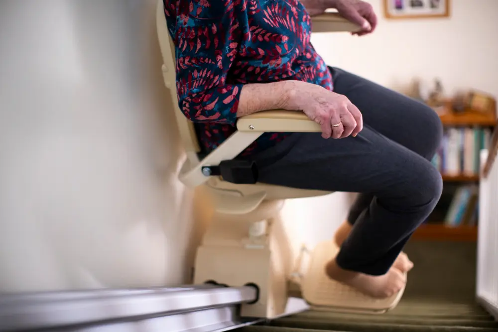 Older woman sat on a stairlift