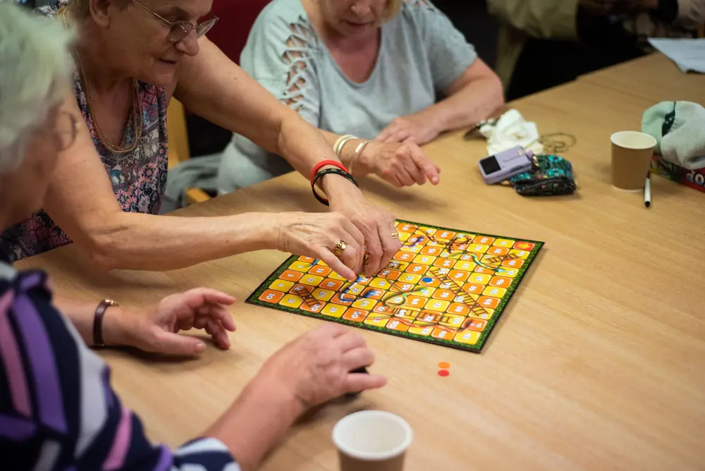 Older women playing snakes and ladders