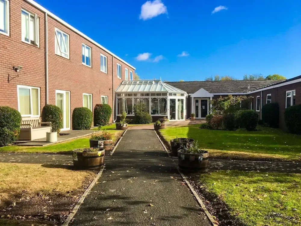 The Gardens Care Home exterior and garden